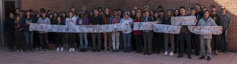 Students in Professor Alicia Volk's Japanese Art class display a narrative hand scroll they created.