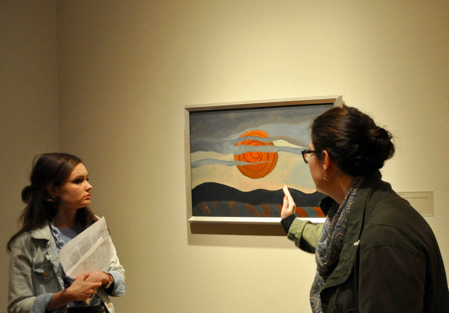 Several UMD art history graduate students examine a painting