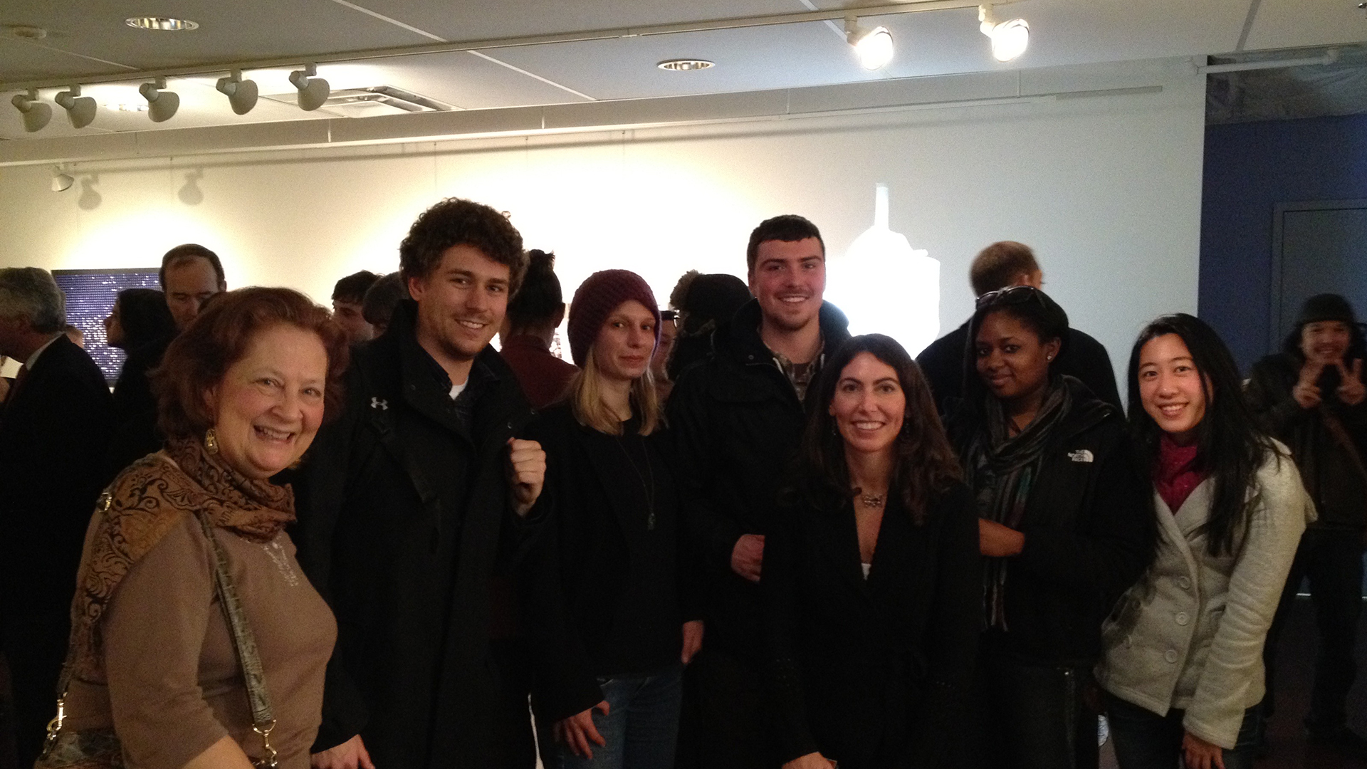Professor Alicia Volk with undergraduate students at museum exhibition