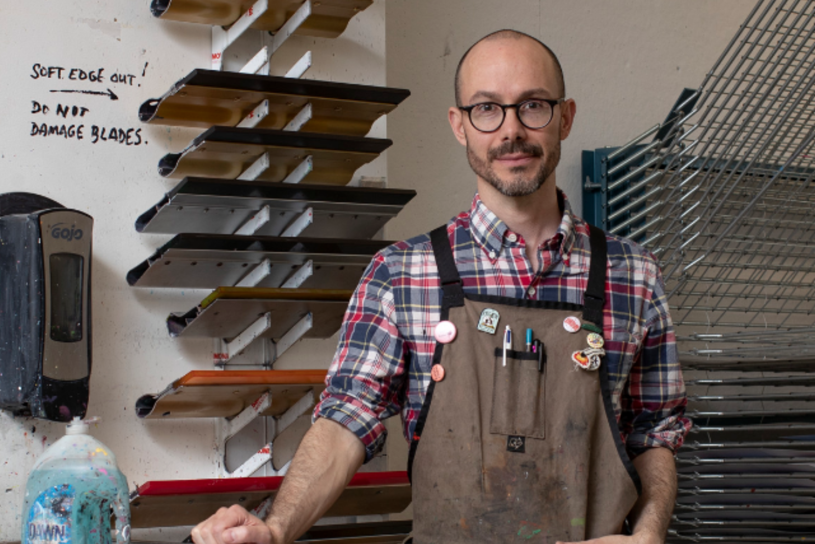 Amze Emmons stands in an art studio.